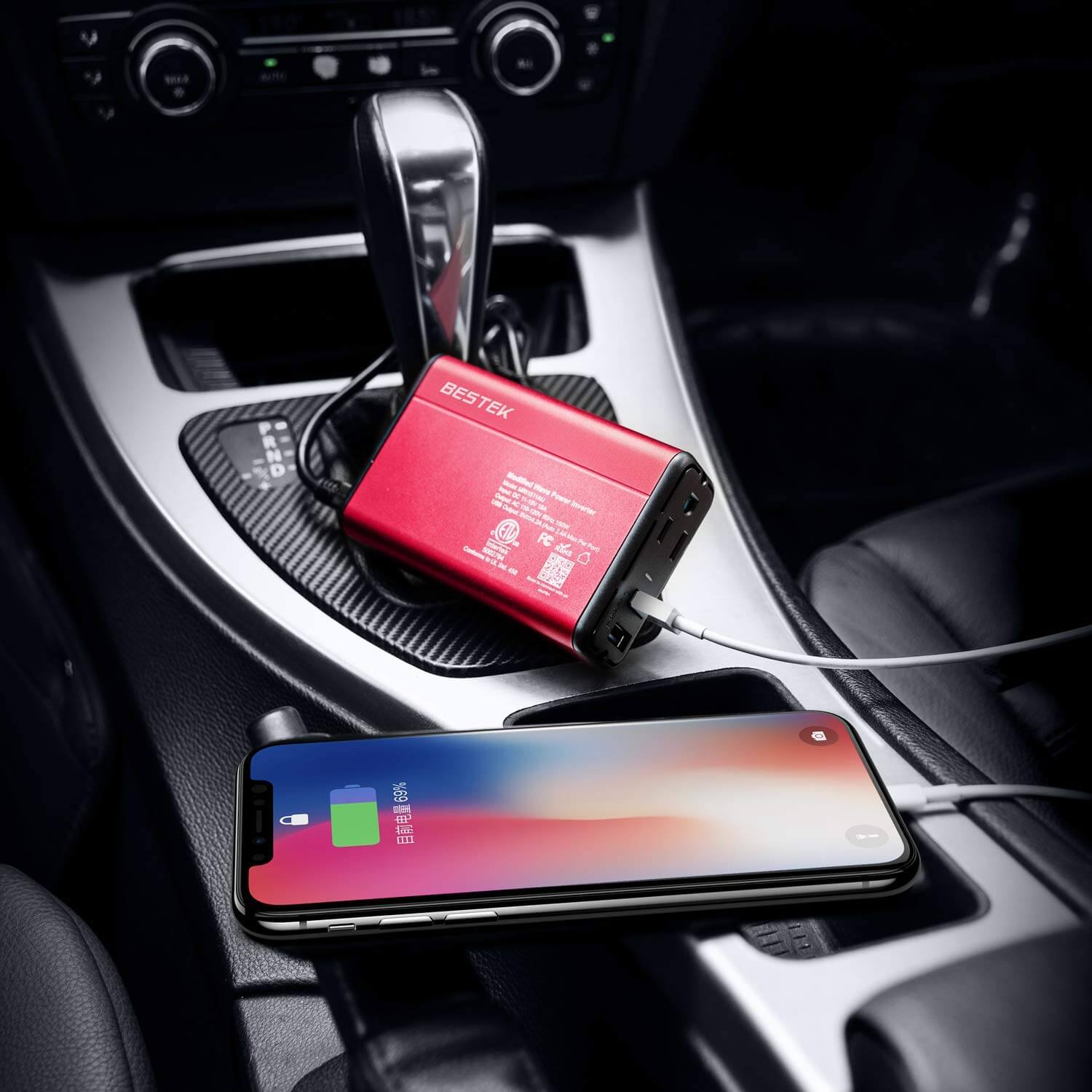 BESTEK 150W inverter — red inverter charging a phone in a car
