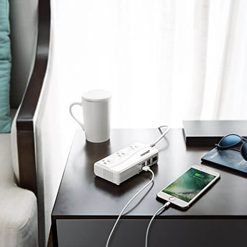 BESTEK travel voltage converter — white converter charging devices on a hotel desk