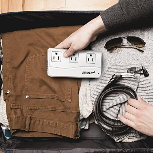 BESTEK travel voltage converter — white converter being packed into a suitcase